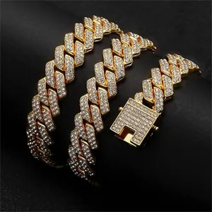 Detail view of a luxury gold-plated iced out Cuban link necklace for men with rhinestones