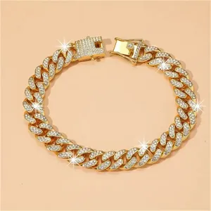 Detail view of a luxury iced out gold Cuban link chain necklace with sparkling rhinestones