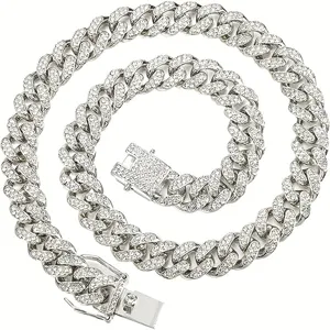 Detailed view of an iced-out silver Cuban link necklace with sparkling rhinestones.