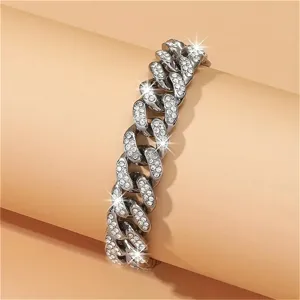 Detailed view of silver iced out Cuban link chain with shimmering rhinestones