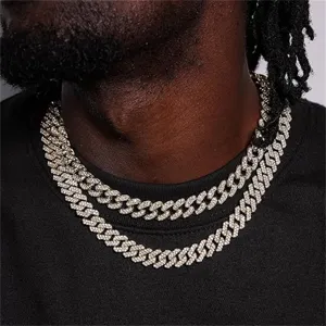 Close-up of 12mm iced out Cuban link necklaces on a male model's neck.