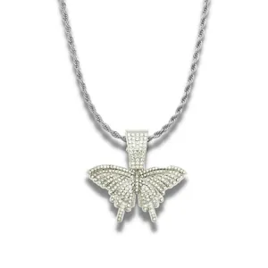 Close-up macro view of a silver-toned hip hop butterfly pendant paved with white rhinestones