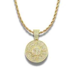Detailed view of hip hop gold pendant necklace encrusted with shimmering crystals