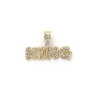 Close-up of hip hop KING pendant with sparkling clear rhinestones in gold finish.