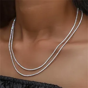 Close-up detail of a layered sparkling 14mm tennis necklace worn elegantly on a neck