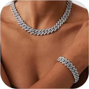 Close-up of a sparkling silver-tone double-row diamond Cuban link necklace and bracelet set