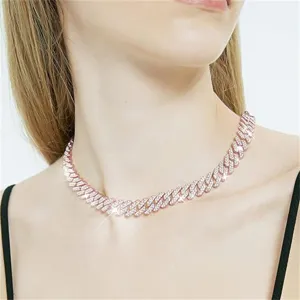 Detailed macro shot of an iced out rose gold Cuban link necklace worn by a model