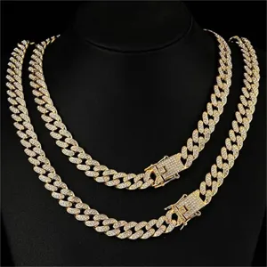 Close-up detail of iced-out gold Cuban link necklace for men with rhinestone pavé design.