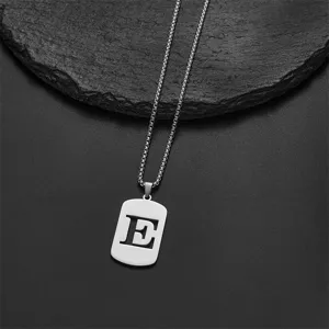 Detail of stainless steel rectangular pendant with cutout alphabet letter E