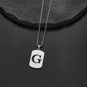 Detail view of a silver stainless steel necklace featuring an engraved letter G pendant