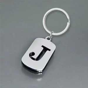 Detailed view of the hollowed-out letter J on a polished stainless steel keychain