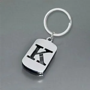 Detailed macro view of a silver stainless steel keychain featuring a hollowed-out letter K