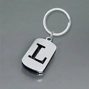 Close-up view of a polished stainless steel keychain pendant with a hollowed letter L design