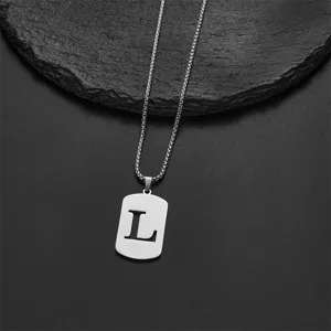 Macro view of silver stainless steel dog tag necklace with letter L cutout design