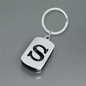 Detailed macro shot of a stainless steel keychain with a polished hollow letter S pendant