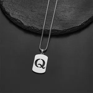 Close-up of a silver stainless steel necklace with a hollowed letter Q pendant.