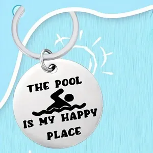 Detailed macro view of a stainless steel keychain with pool themed engraving and swimmer