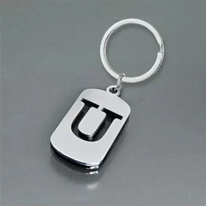Close-up of a minimalist stainless steel keychain with letter U cutout design