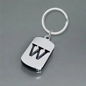 Detailed macro view of a stainless steel keychain with a cut-out letter W design