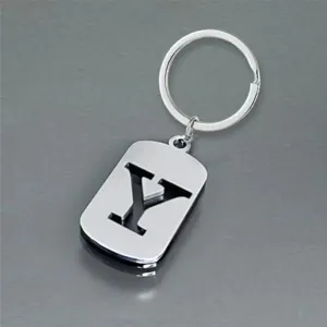 Close-up of a silver stainless steel keychain with a hollow-out letter Y design.