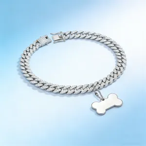 Detail showing a silver Cuban link pet collar with rhinestones and bone pendant.
