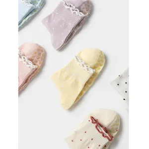 Detailed view of pastel ruffle edge anti-slip socks with heart-shaped silicone grips