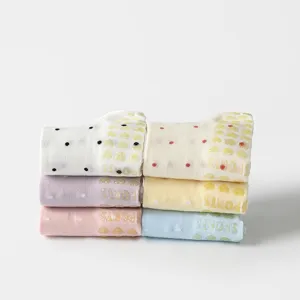 Stack of colorful anti-slip Pilates yoga socks featuring polka dots and heart-shaped silicone grips