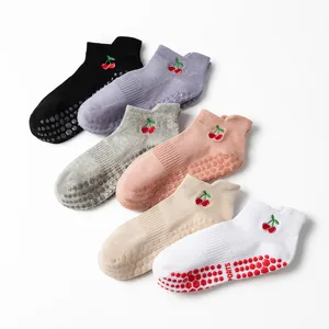 Detail of non-slip yoga socks with cherry embroidery and silicone honeycomb grips