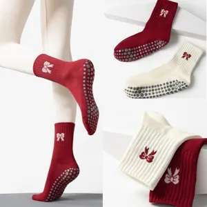 Close-up of non-slip yoga socks with bow pattern and hexagonal silicone grips