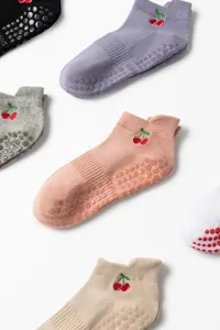 Detail view of non-slip Pilates yoga socks with cute cherry embroidery