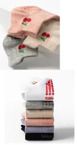Close-up of non-slip yoga socks with cherry embroidery and SPORTS logo grippers.