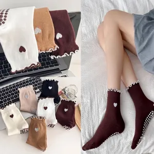 Non-slip yoga socks featuring cute heart embroidery and ruffled lace edge detail