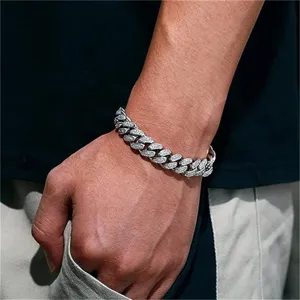 Detailed close-up of an iced-out silver Cuban link bracelet for men worn on a wrist