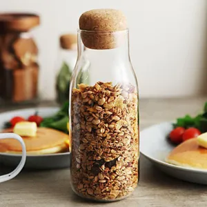 Clear borosilicate glass storage jar with round cork lid for kitchen organization.