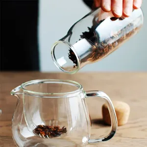 High borosilicate glass storage jar with cork stopper shown pouring tea leaves