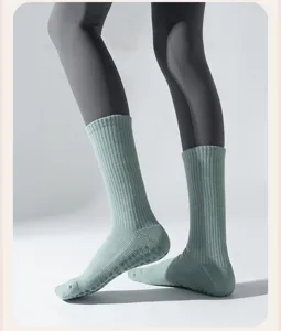 Close-up of thick ribbed cotton yoga socks featuring non-slip silicone dots on the soles