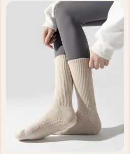 Detailed macro view of thick cotton yoga socks with non-slip silicone grips on the sole.