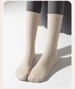 Close-up of beige ribbed crew length yoga socks with thick terry cotton texture
