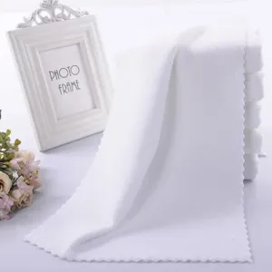 Soft white microfiber towel with scalloped edges for hotel or salon
