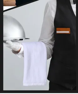 Professional white cotton towel draped on a waiter's arm in a luxury restaurant setting.