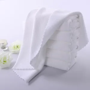 Detail view of pure white soft absorbent towels with decorative scalloped edges