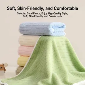 Close-up of soft ribbed coral fleece towels in multiple pastel colors and white edges.