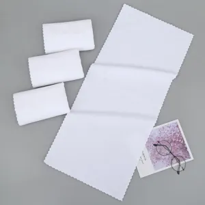 Detailed view of white absorbent disposable towels with wavy edges for travel and hotel use.