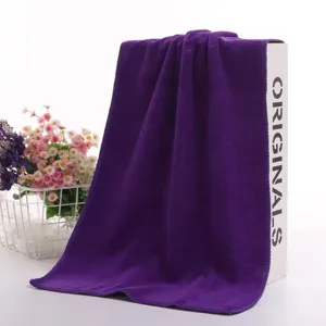 Detail shot of a thick purple microfiber cleaning towel with high water absorption.