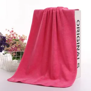 Detailed macro view of pink microfiber cleaning cloth with soft absorbent texture.