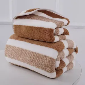 Soft brown and white striped coral fleece bath towel set with thick absorbent texture.