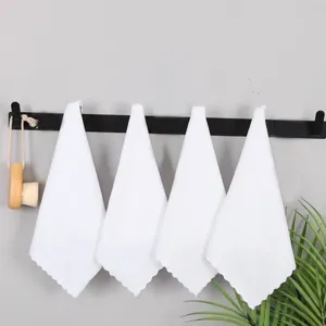 Set of four white absorbent square towels hanging on a modern black bathroom rack