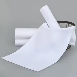 Macro view of absorbent warp-knitted white disposable cleaning cloth with zigzag edges