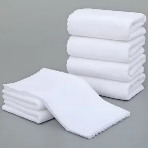 Macro view showing the soft warp-knitted texture of disposable white towels for cleaning