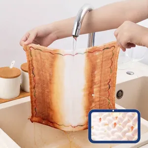 Wood fiber oleophobic dishcloth showing easy oil stain removal under running water
